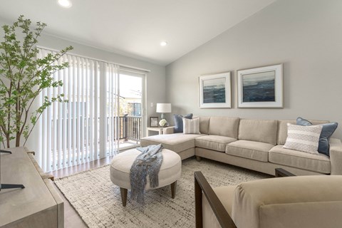 a living room with a couch and a chair and a table